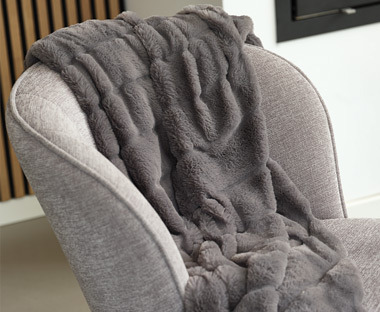 Grey Fake fur throw on top of armchair