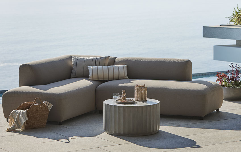 All-weather lounge sofa in beige and lounge table on a balcony 